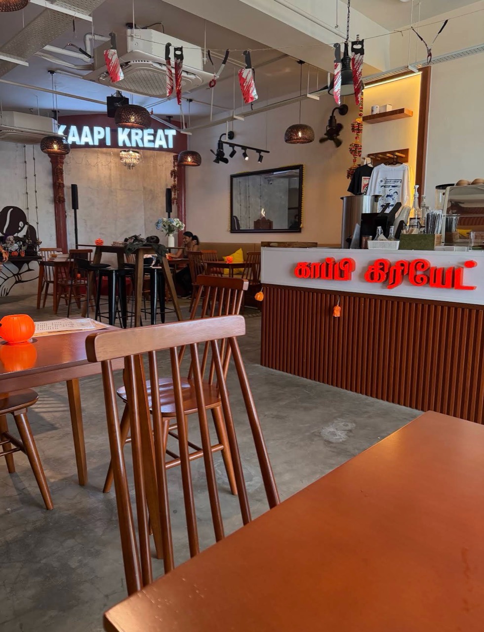 Inside the Tamarind Square café, with wooden tables and the coffee counter